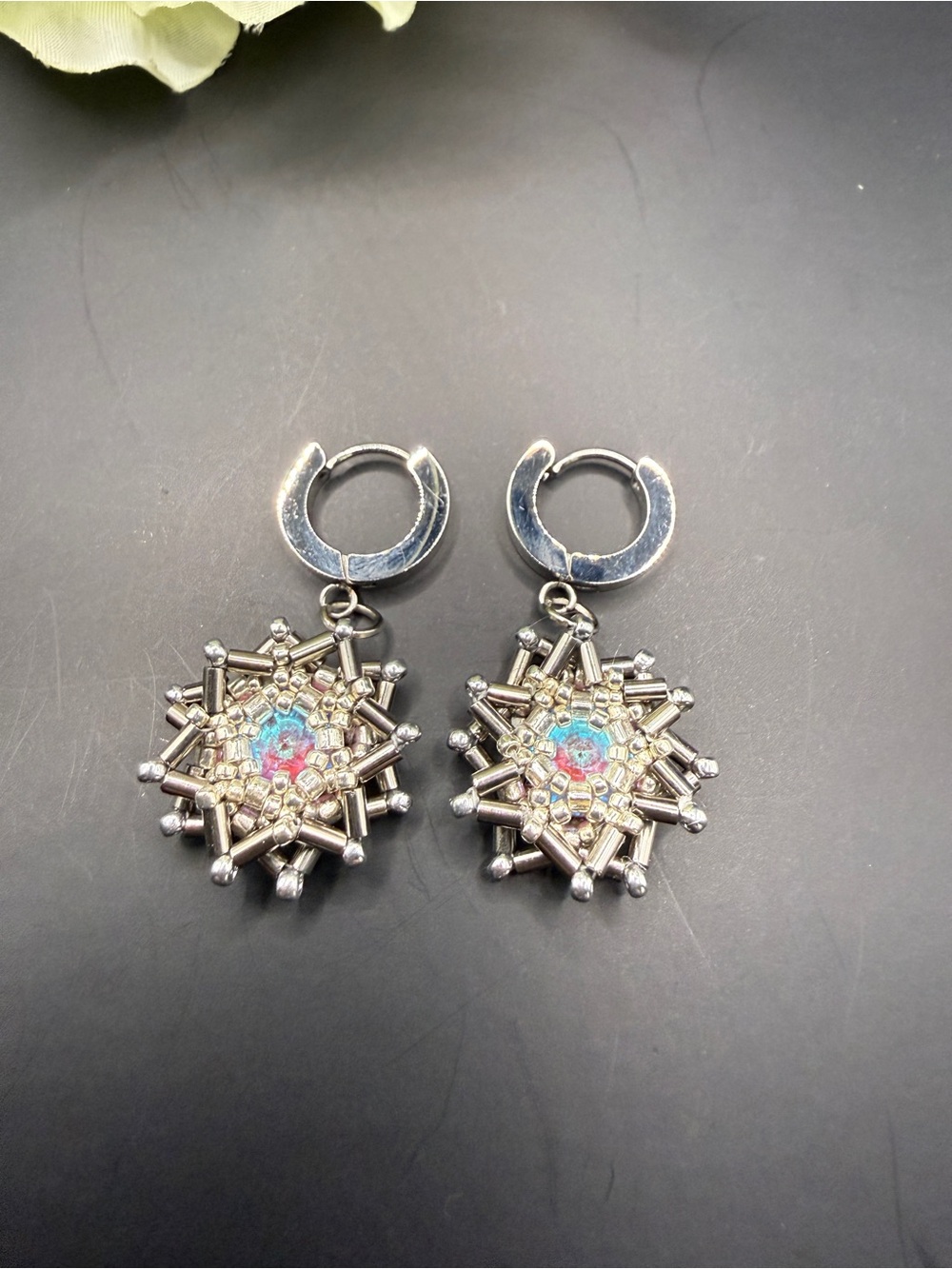 Silver Snowflake Drop Earrings with Iridescent Blue-Pink Center